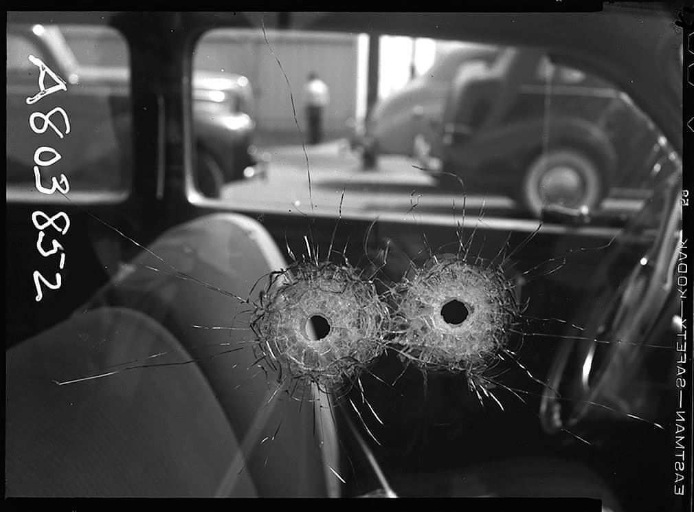 Forensic detail of bullet holes in a car window – 1942.jpg